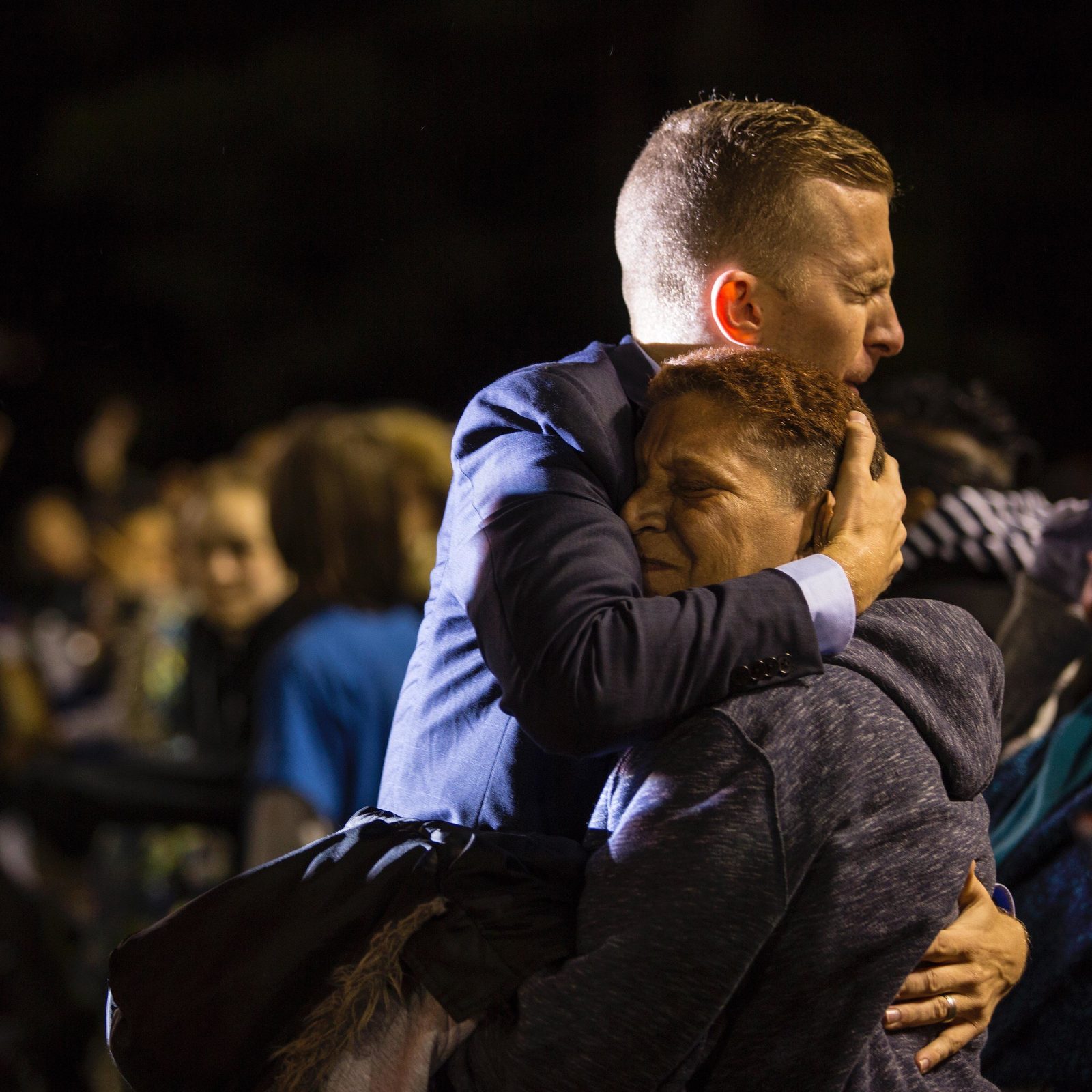 A minister embracing a woman during an altar call
