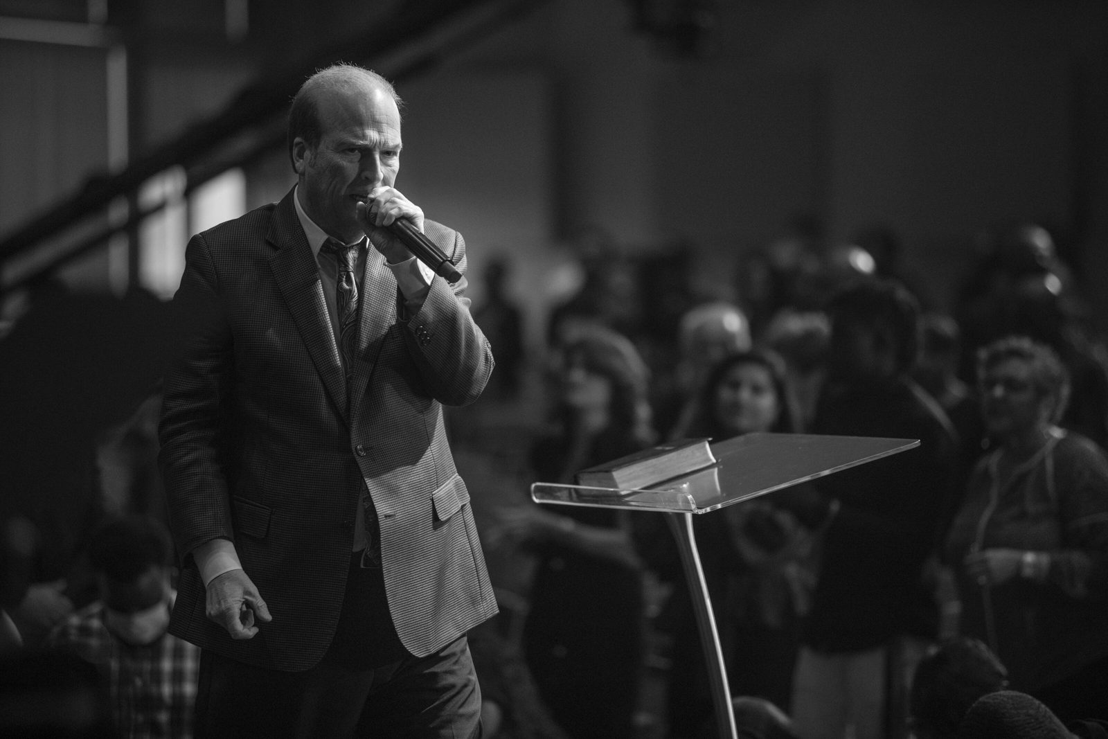 Black and white photo of an evangelist preaching at a camp meeting
