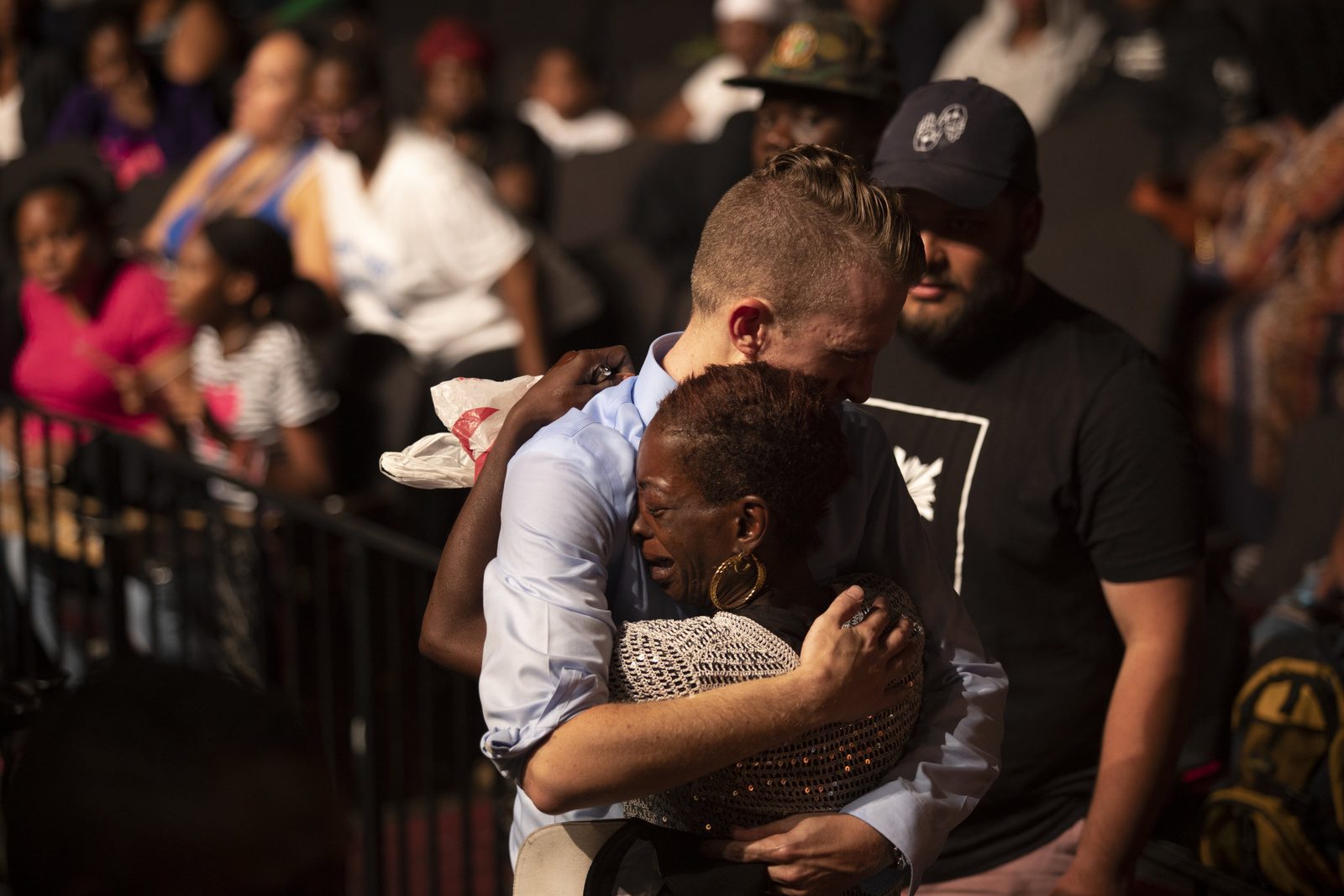 A minister embracing a woman in the crowd at an evangelistic crusade
